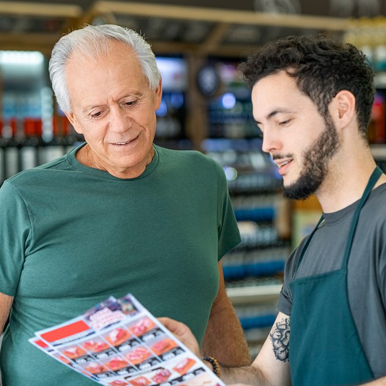 two men looking at flyer