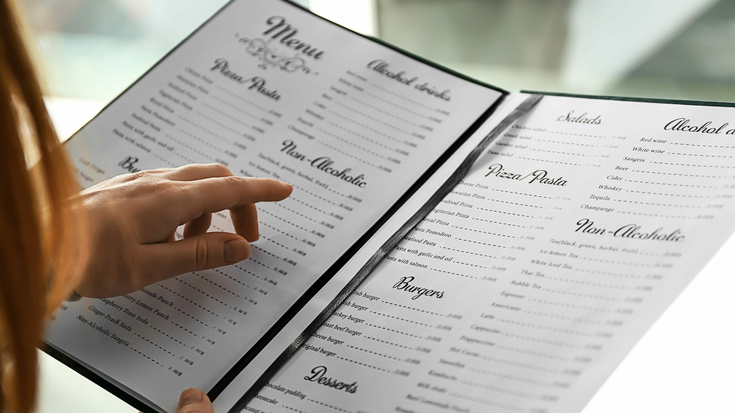 Woman reading menu in cafe, closeup